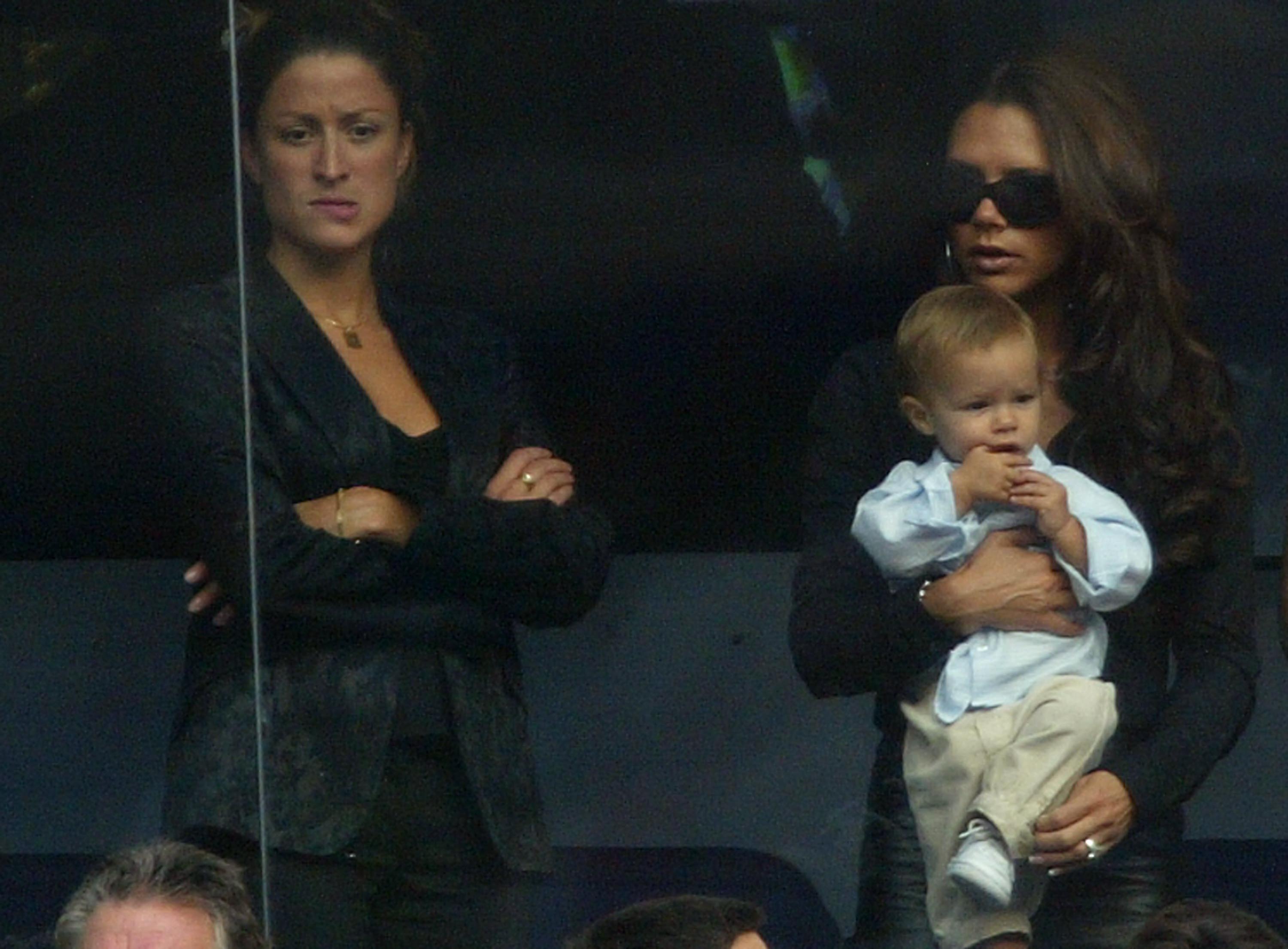 Rebecca Loos, alleged to have had an affair with David Beckham, stands next to Victoria Beckham while watching a Real Madrid soccer game.