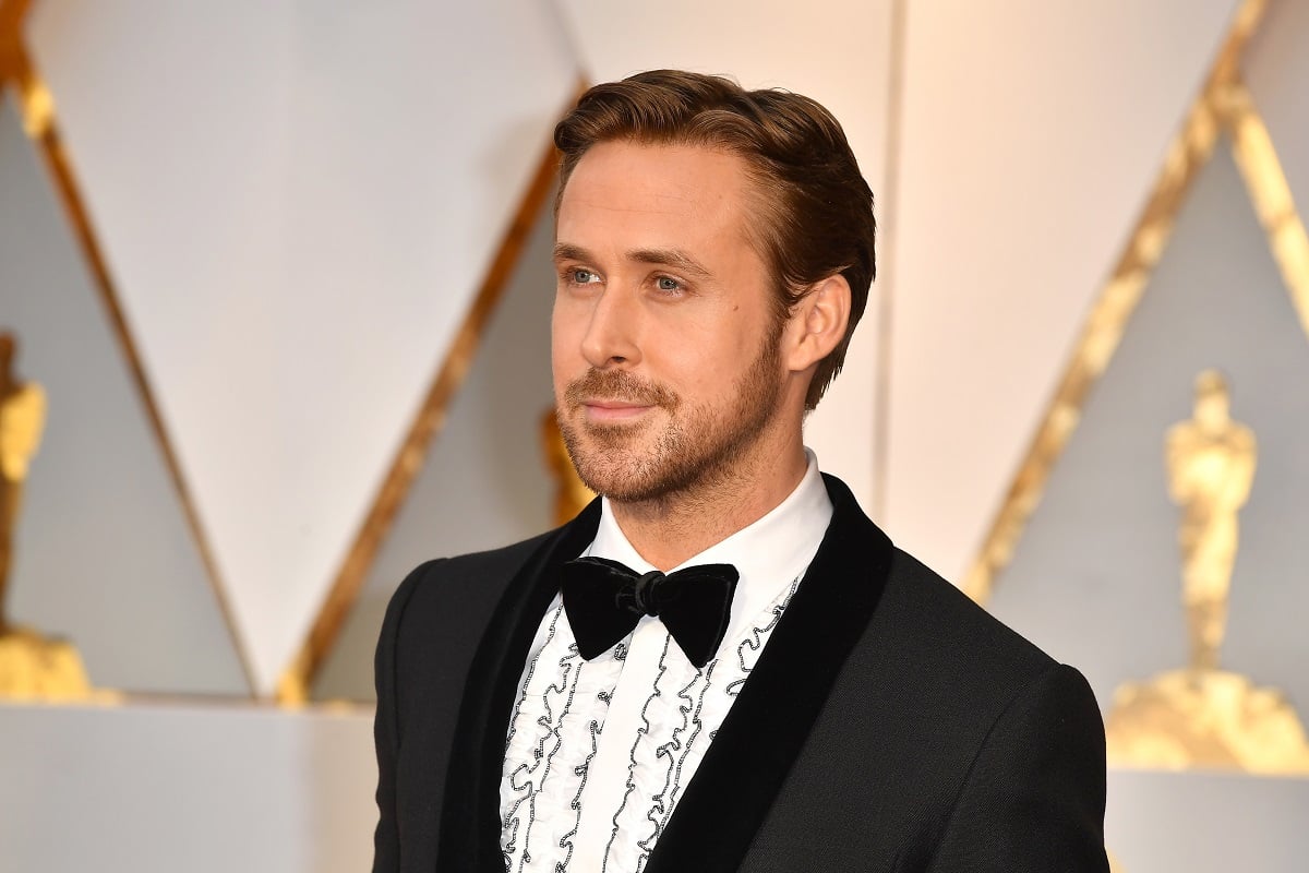 Ryan Gosling posing in a suit and bowtie at the Academy Awards.