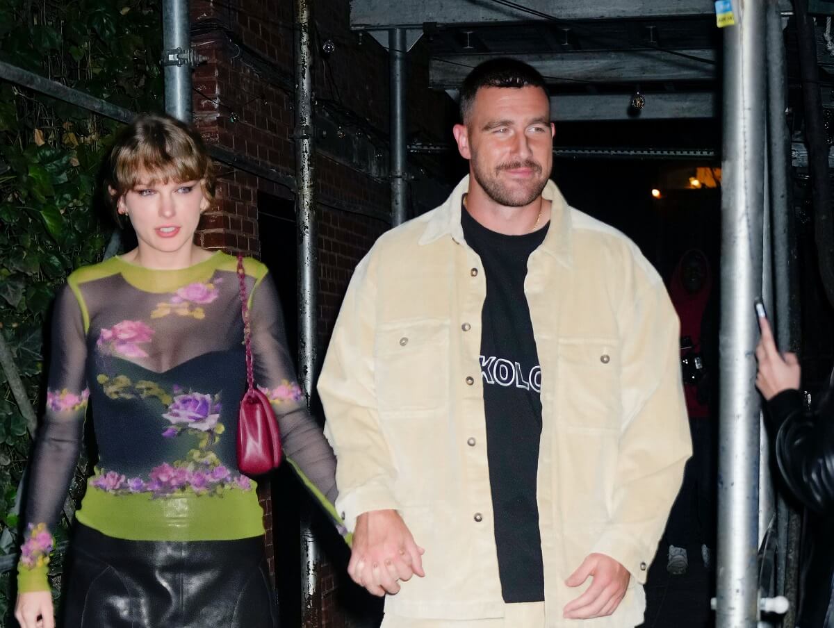 Taylor Swift, who used her signature dating move by meeting Travis Kelce's mom, holds hand with the football player as they leave a dinner in New York City