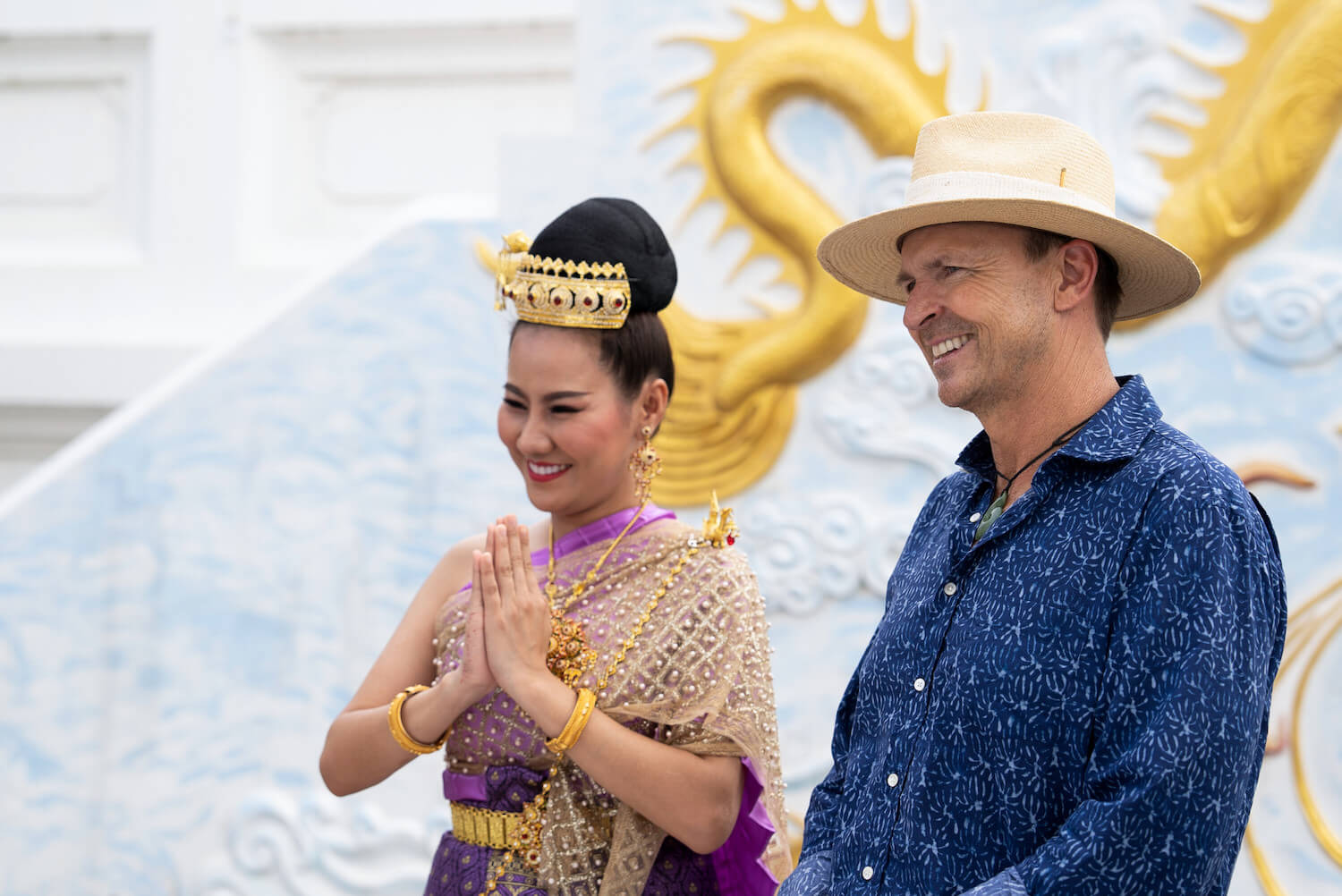 Phil Keoghan standing at the end of the first leg with a woman from Thailand in 'The Amazing Race' Season 35
