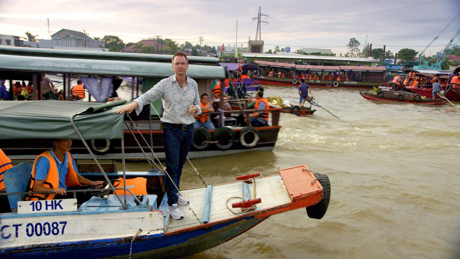 Phil Keoghan standing on a boat in 'The Amazing Race' Season 35