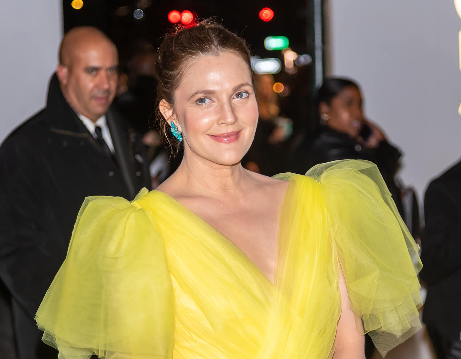 Drew Barrymore from 'The Drew Barrymore Show' dressed in a yellow gown at an event