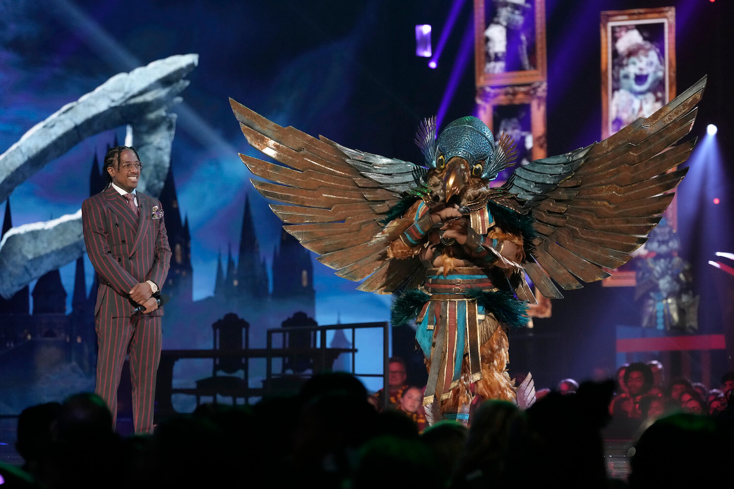 Hawk standing next to Nick Cannon in 'The Masked Singer' Season 10
