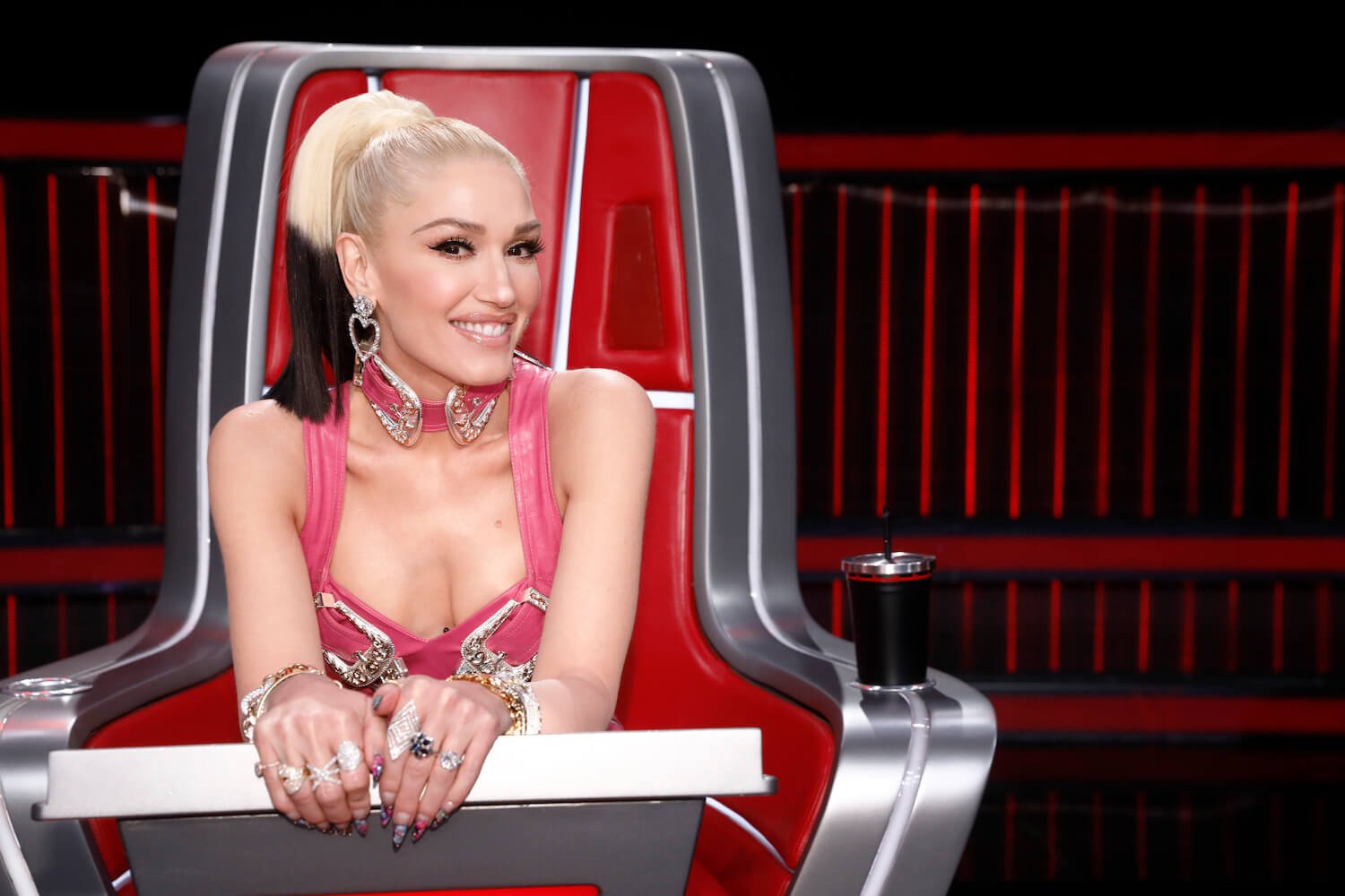 'The Voice' Season 24 coach Gwen Stefani leaning over the coach's chair and smiling