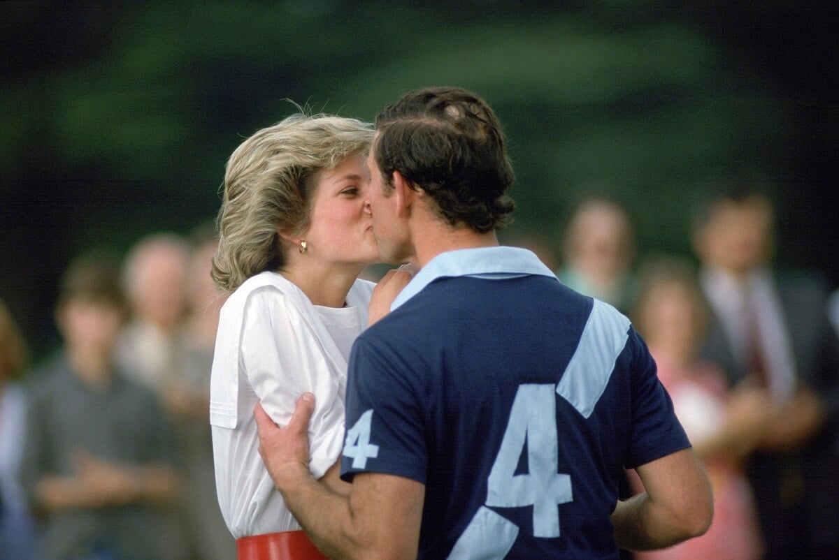 Then-Prince Charles kisses Princess Diana after she presents him with a prize at a polo match