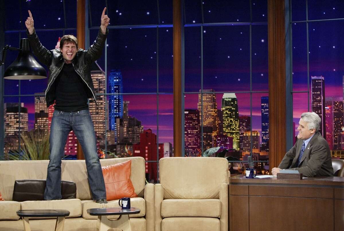 Tom Cruise jumps on a couch during an interview with Jay Leno