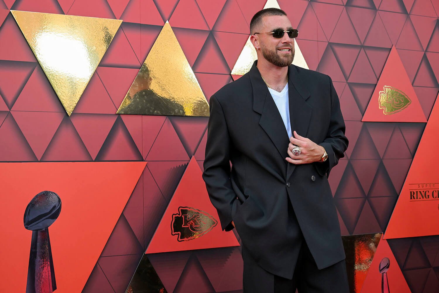 Travis Kelce in a suit and sunglasses at an event