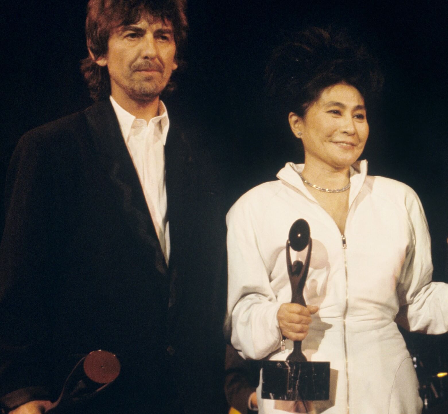 George Harrison standing next to Yoko Ono