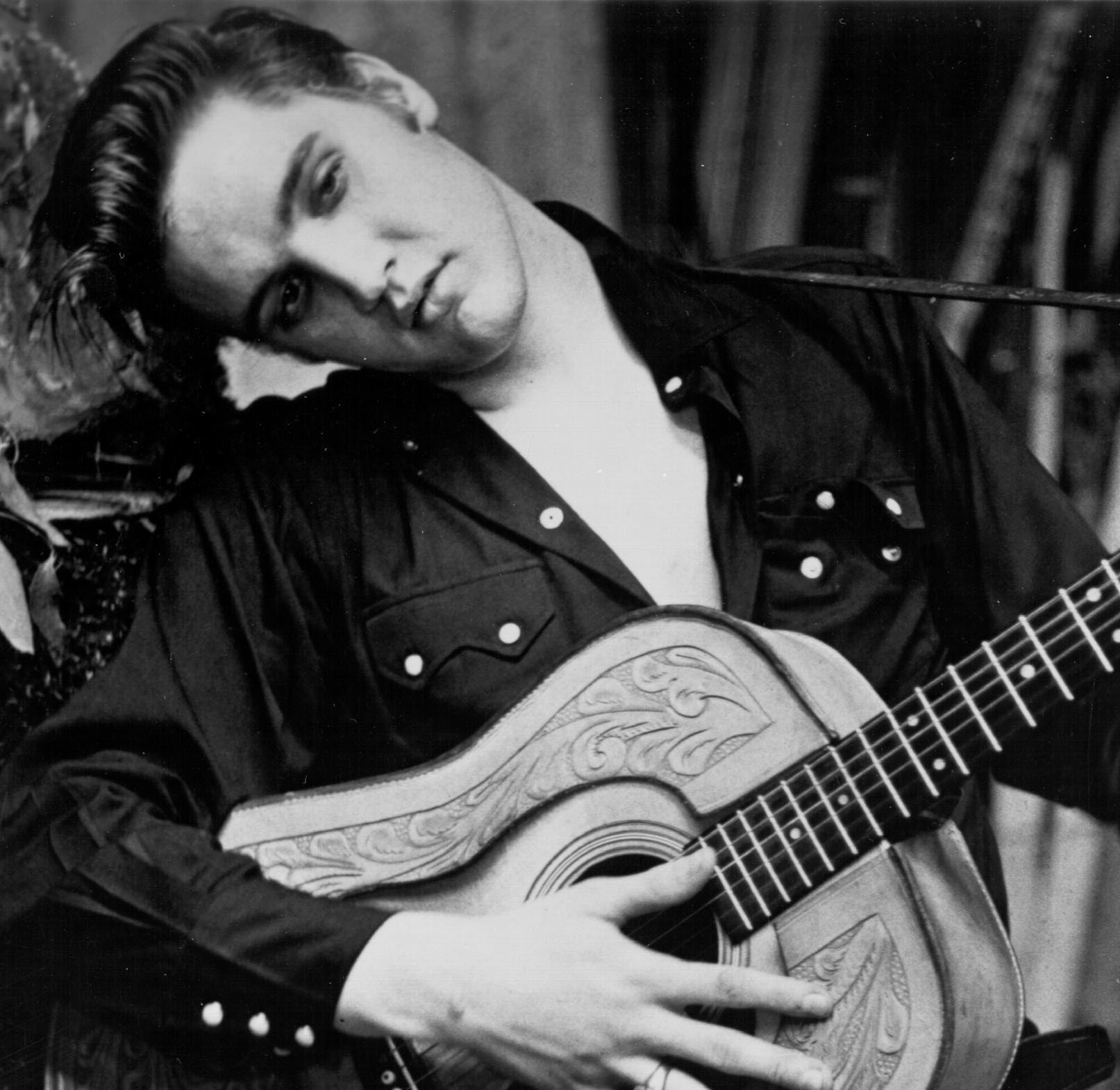 Elvis Presley holding a guitar