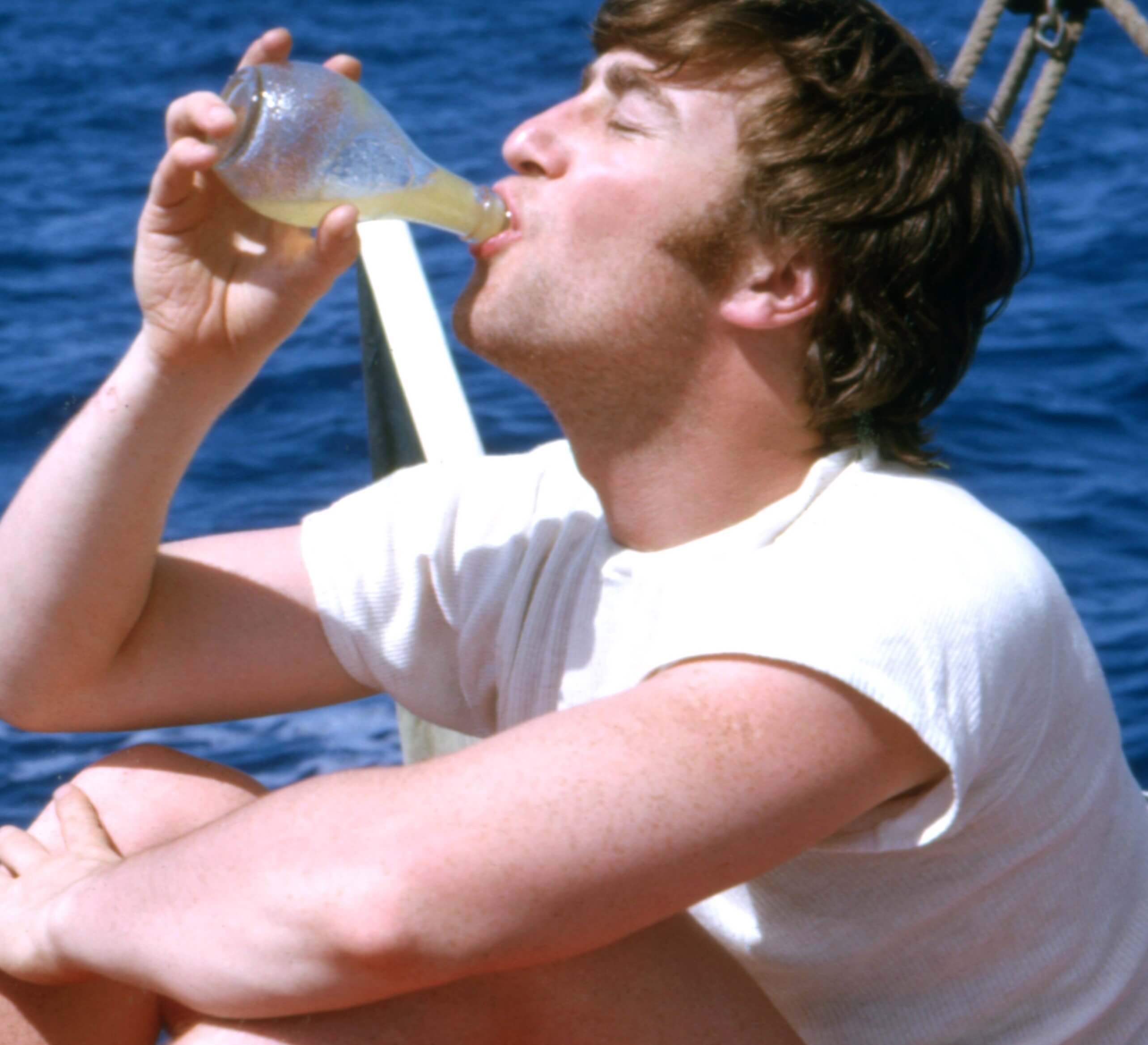 John Lennon with a drink in his hand