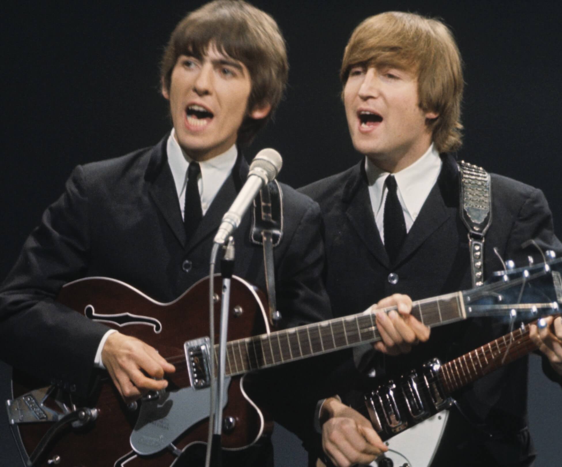 George Harrison and John Lennon wearing suits