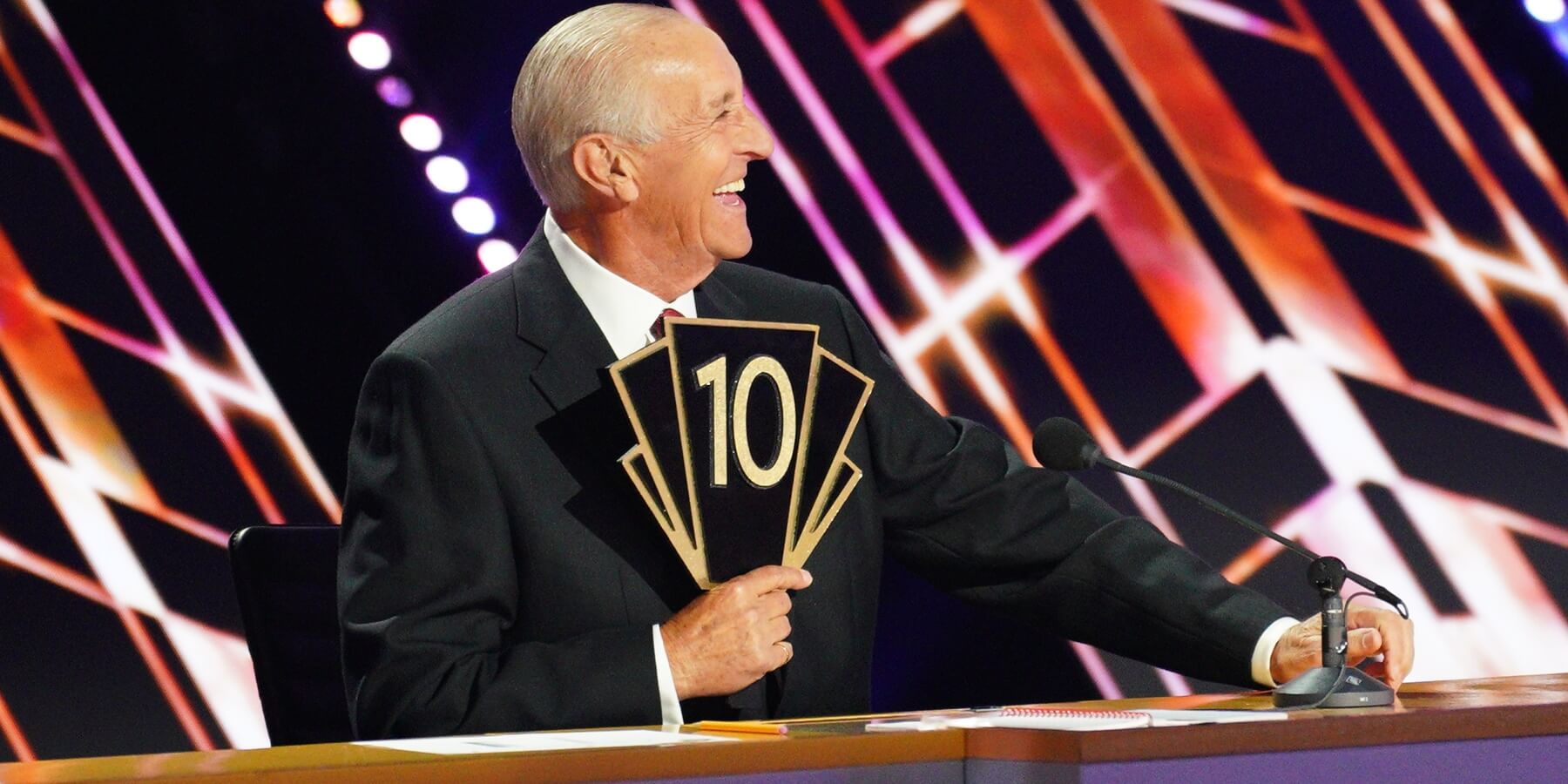 'Dancing With the Stars' late head judge Len Goodman pictured holding his iconic '10' paddle.