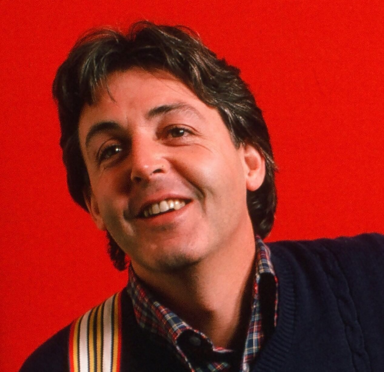 Paul McCartney with a red background