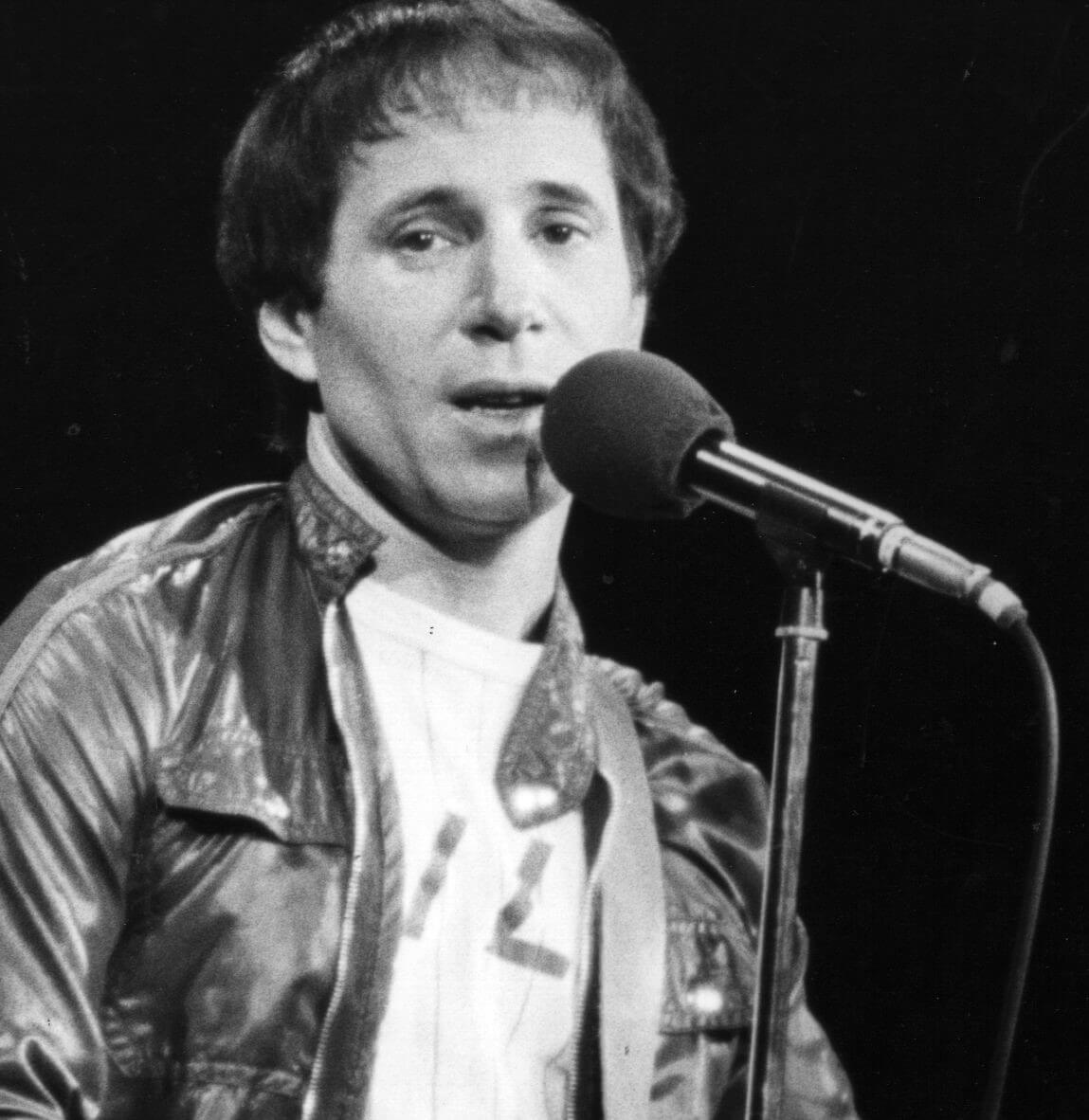 "Bridge Over Troubled Water" star Paul Simon with a microphone