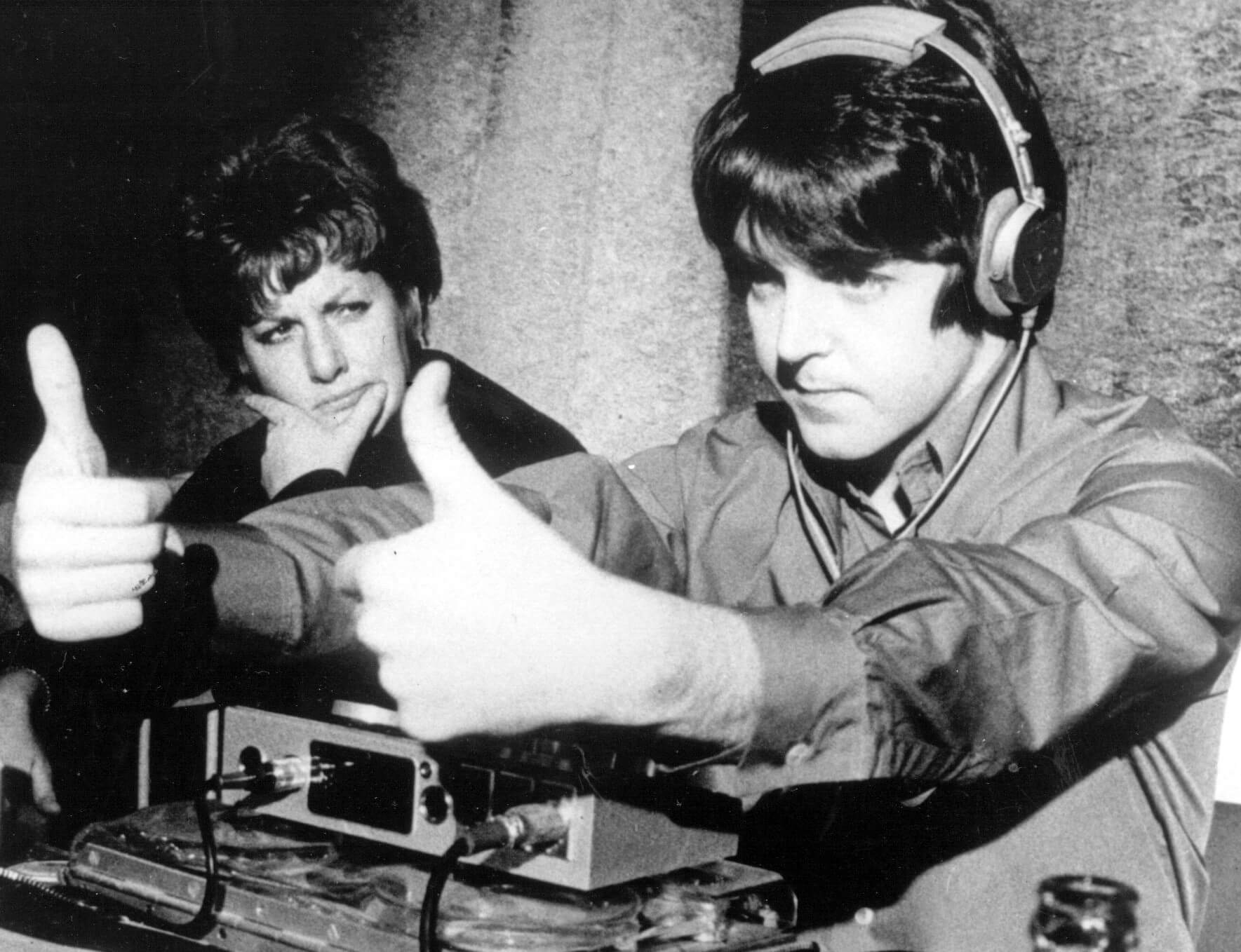 The Beatles' Paul McCartney wearing headphones