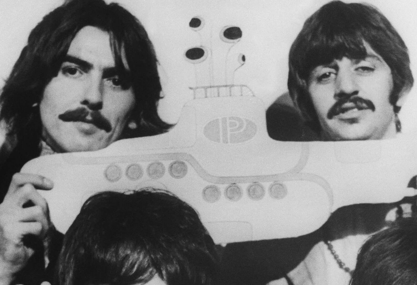 The Beatles' George Harrison and Ringo Starr holding a yellow submarine