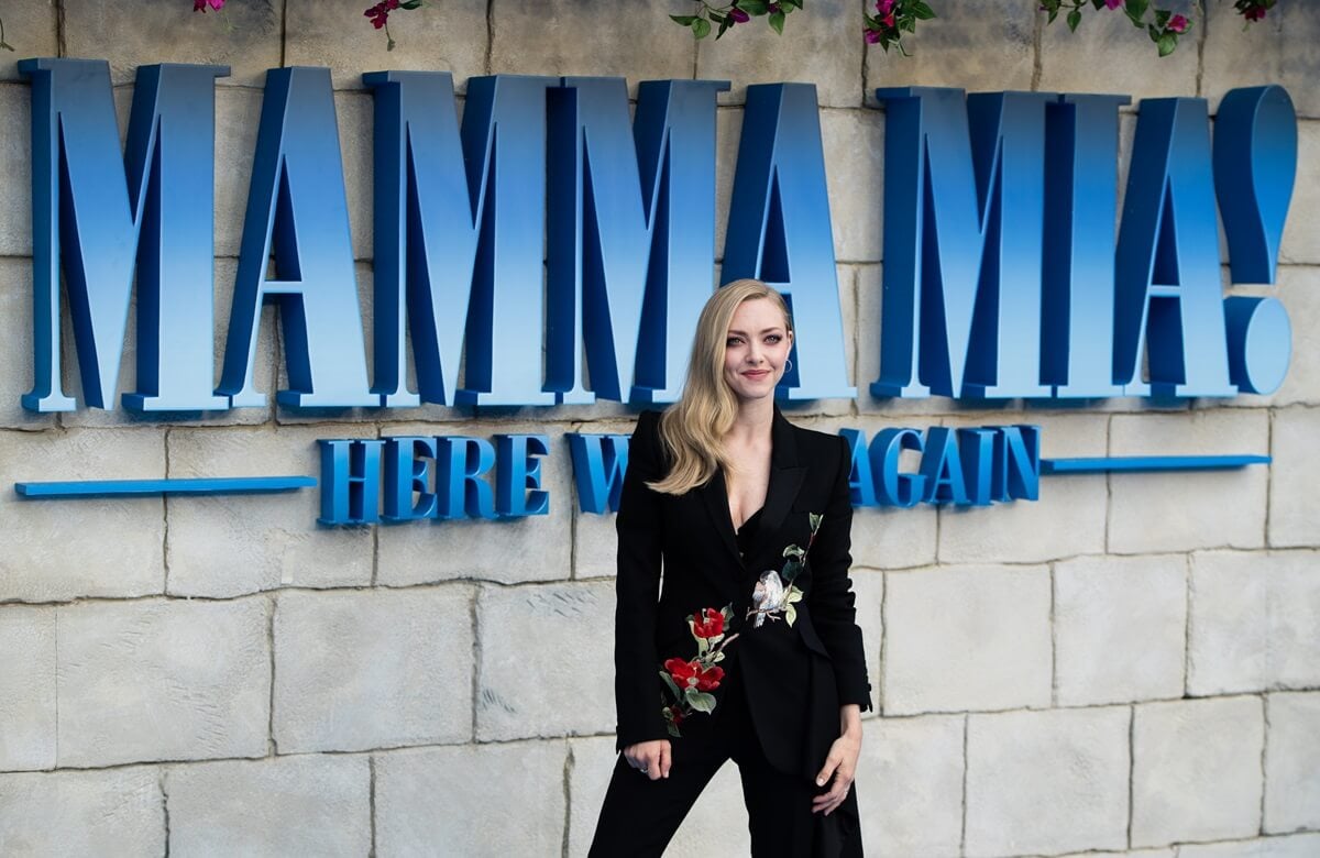 Amanda Seyfried posing in a black suit at the 'Mamma Mia: Here We Go Again' premiere.