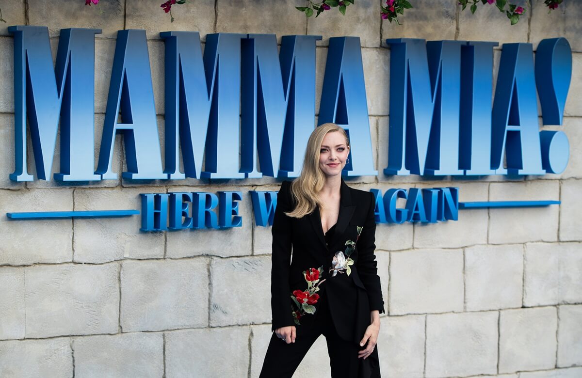 Amanda Seyfried posing in a black suit at the 'Mamma Mia: Here We Go Again' premiere.