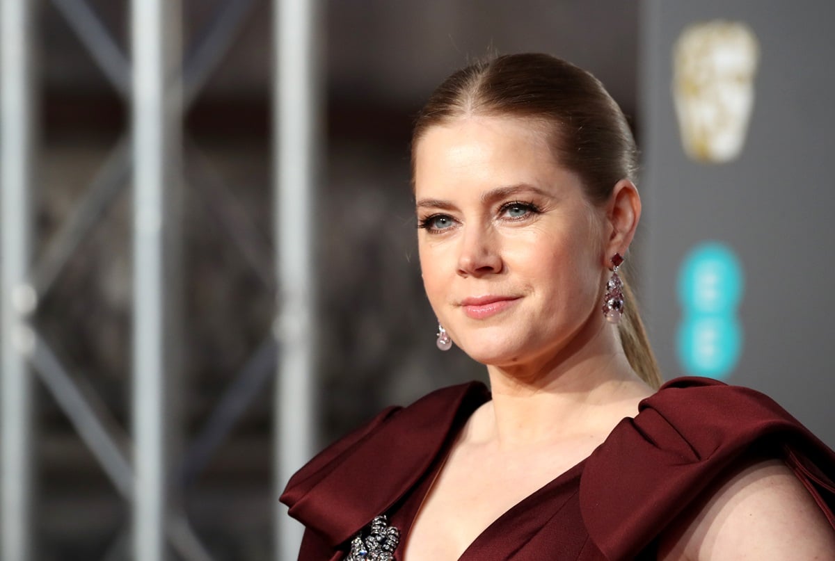 Amy Adams posing at the British Academy Film Awards in a dress.