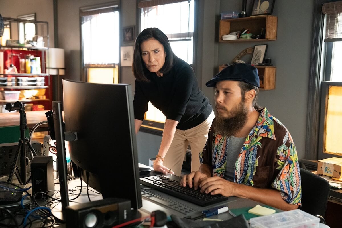 Mo (Stephen A. Chang) and Honey (Mimi Rogers) looking at a computer screen in 'Bosch: Legacy' Season 2