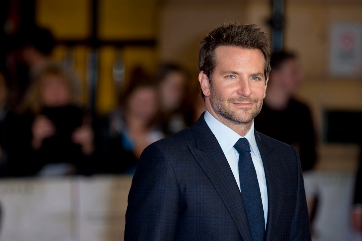 Bradley Cooper posing in a suit at the premiere of the film 'Burnt'.