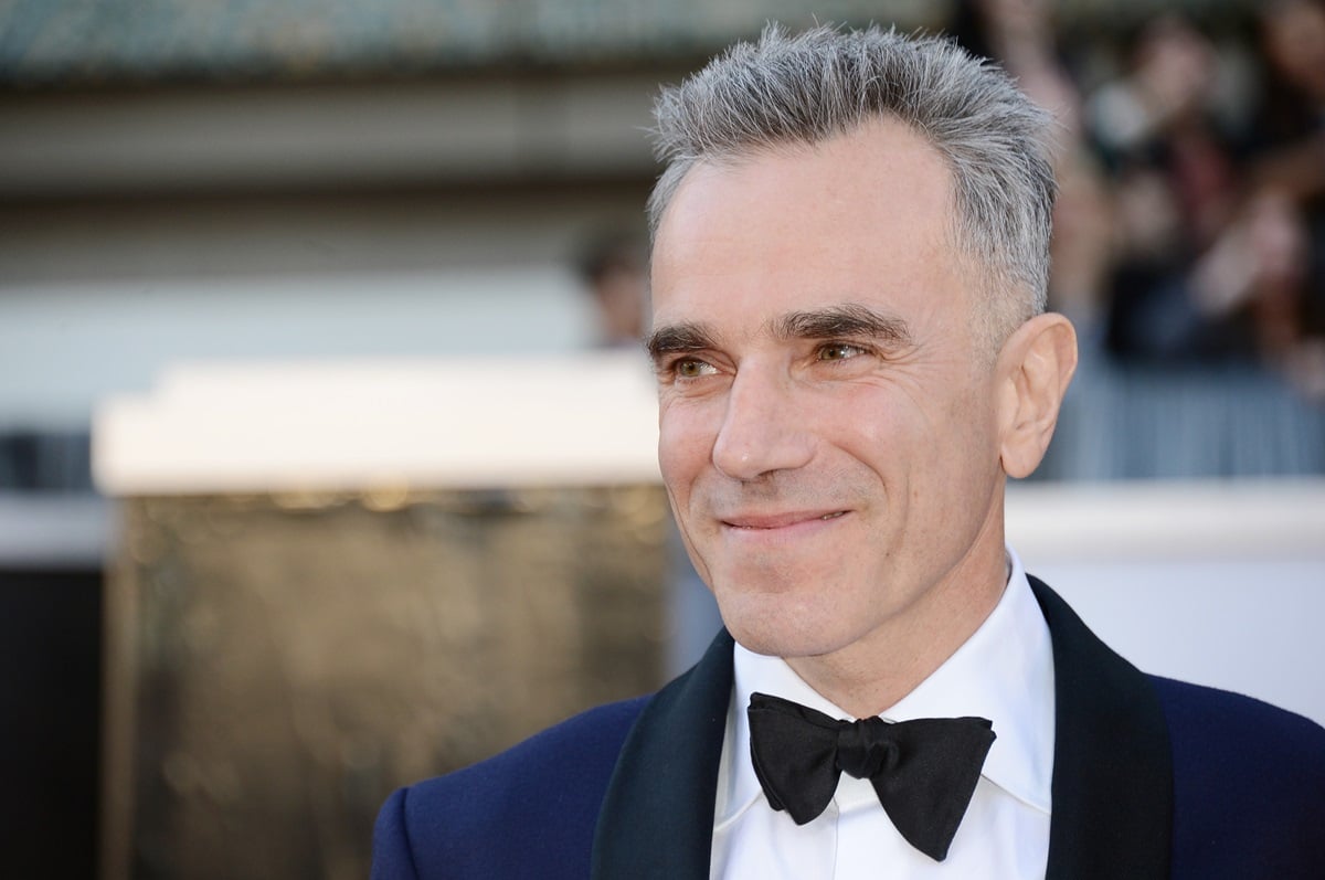 Daniel Day-Lewis posing in a suit at the 8th Academy Awards.