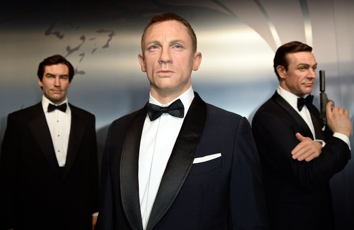 Wax figures of Daniel Craig, Pierce Brosnan, and Sean Connery as James Bond.