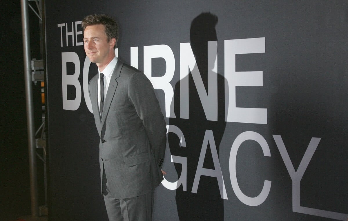 Edward Norton posing in a silver suit at the premiere of 'Bourne Legacy'.