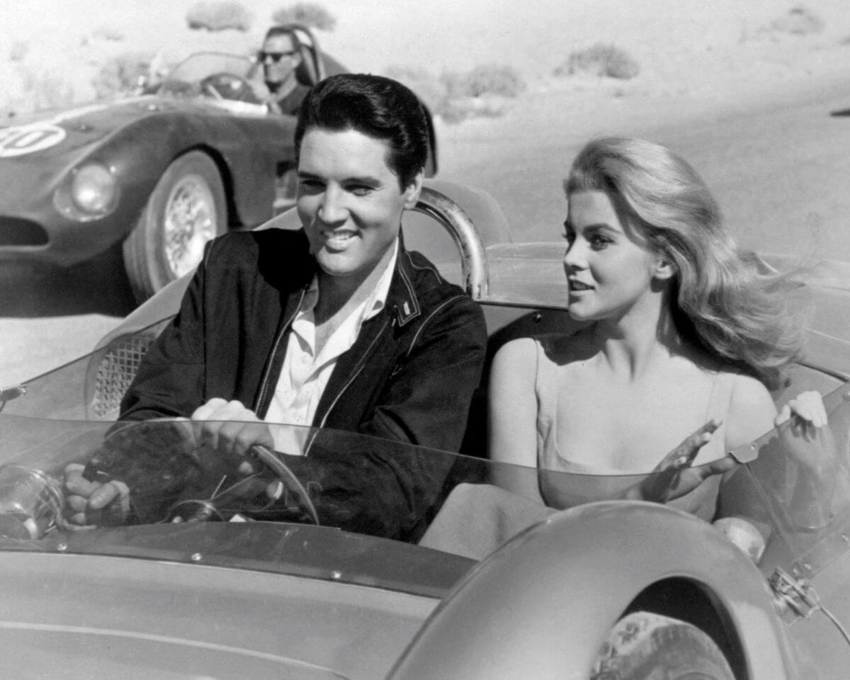 A black and white picture of Elvis and Ann-Margret driving in a convertible in the movie 'Viva Las Vegas.'