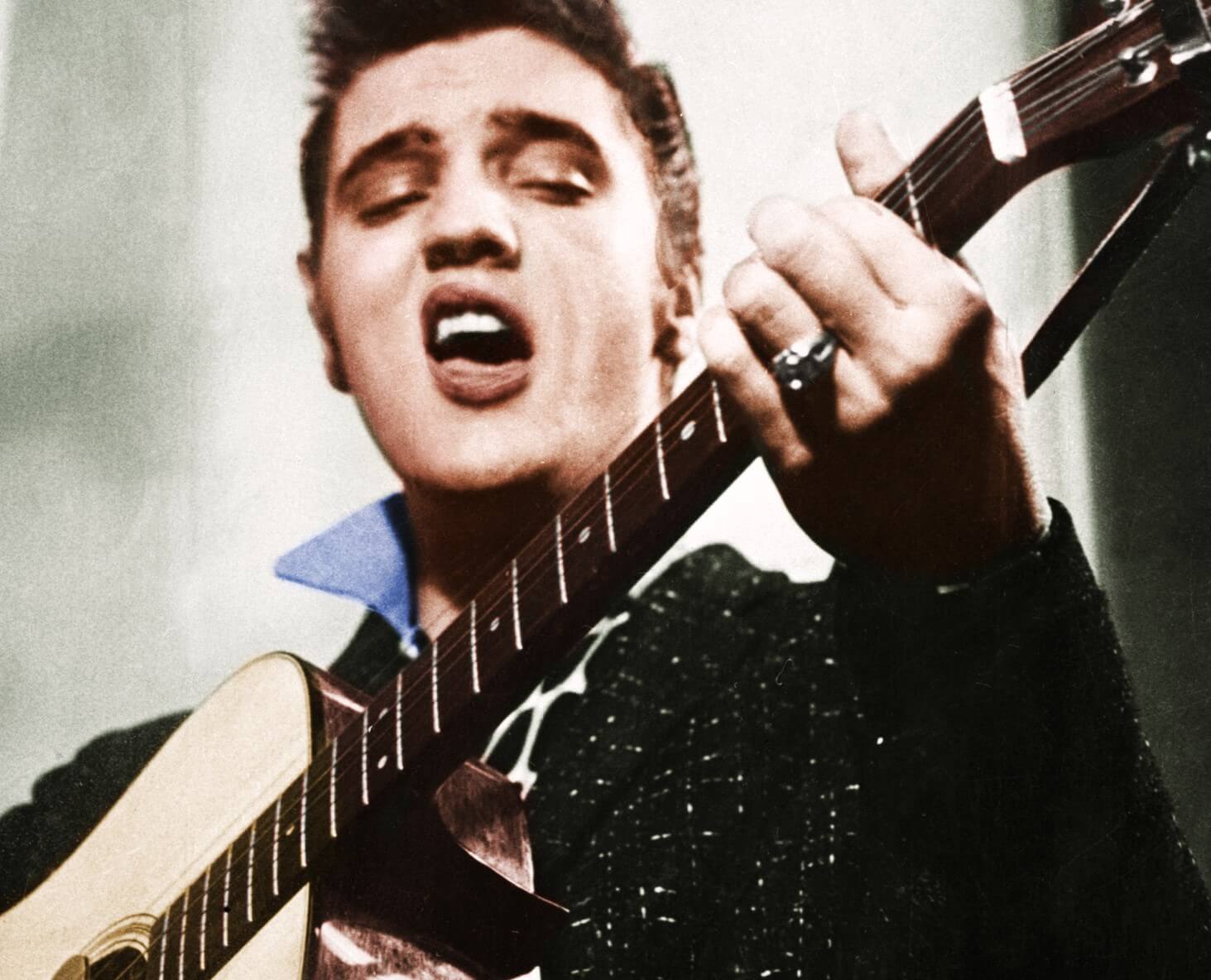 "Are You Lonesome Tonight?" singer Elvis Presley with a guitar