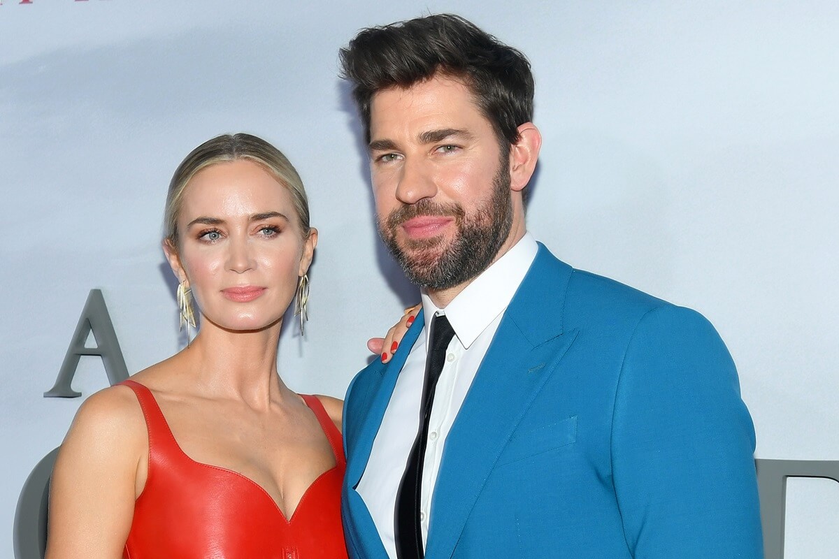 Emily Blunt posing in a red dress and John Krasinski posing in a blue suit at the premiere of 'A Quiet Place II'.