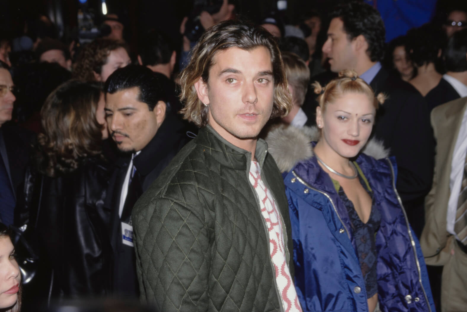 Gavin Rossdale walking next to Gwen Stefani in a crowd in 1997