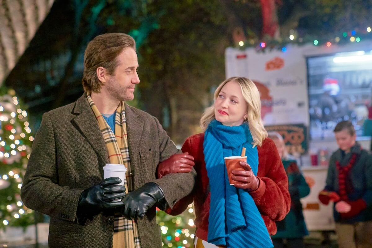 Niall Matter and Emily Tennant holding coffee cups and looking at each other in 'Holiday Hotline'
