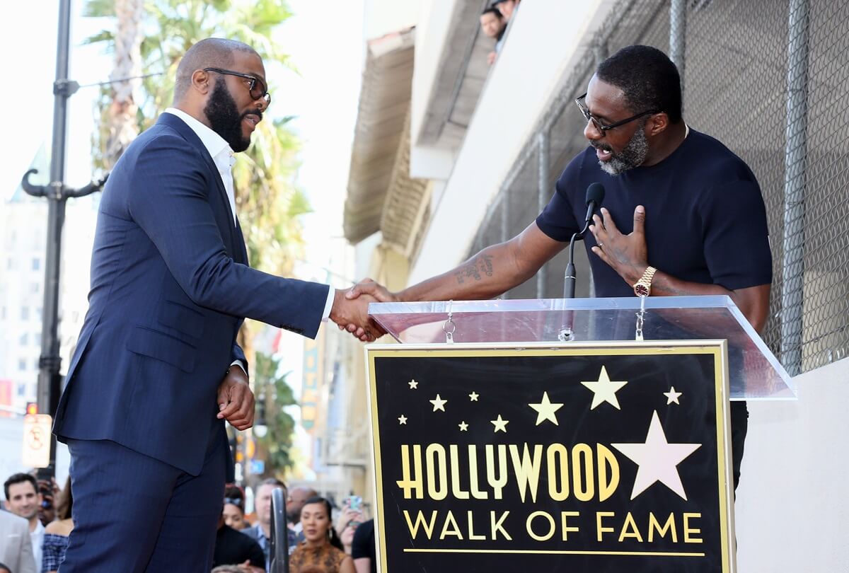 Tyler Perry and Idris Elba shaking hands as Tyler Perry is honored with a Star on the Hollywood Walk of Fame.