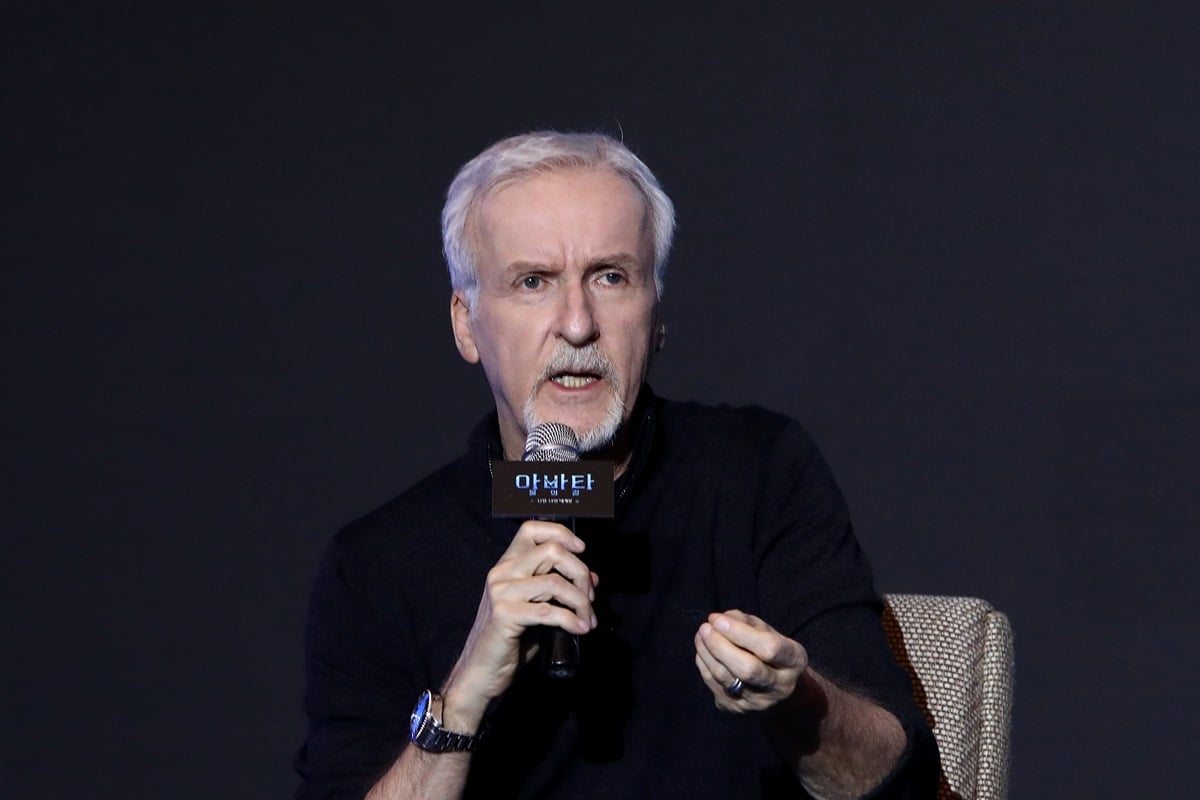James Cameron speaking with a microphone in his hand at the 'Avatar: The Way of Water' press conference.