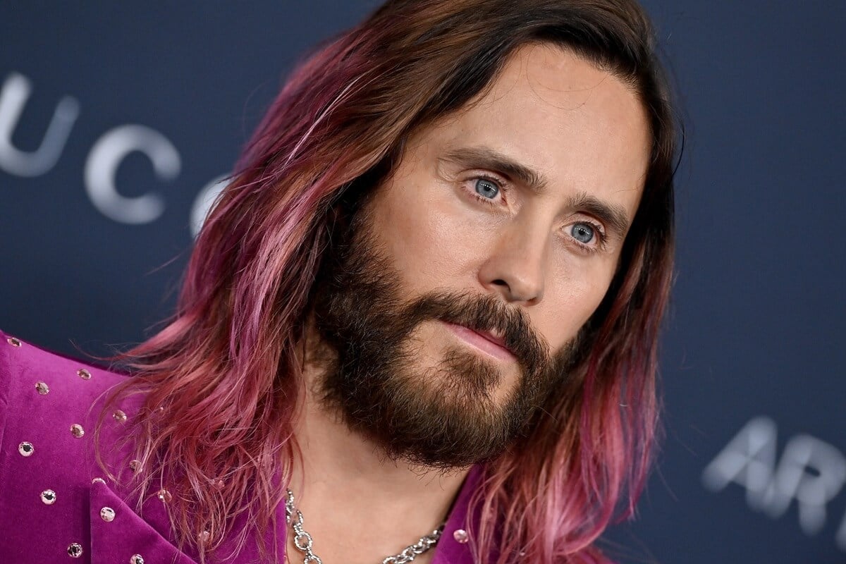 Jared Leto posing at the the 11th Annual LACMA Art + Film Gala in a purple suit.