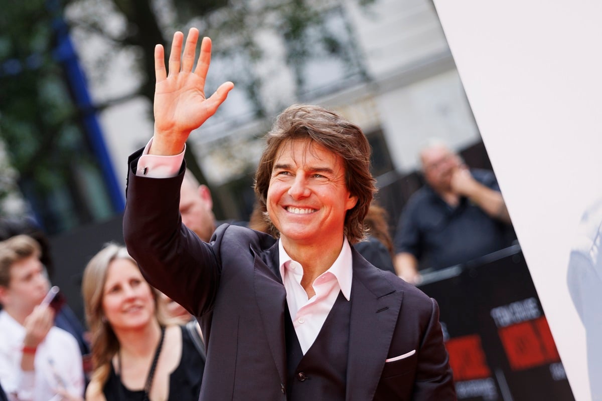Tom Cruise waving his hand at the 'Mission Impossible - Dead Reckoning' premiere.