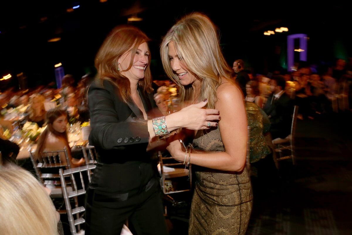 Julia Roberts and Jennifer Aniston hugging each other at TNT's 21st Annual Screen Actors Guild Awards.