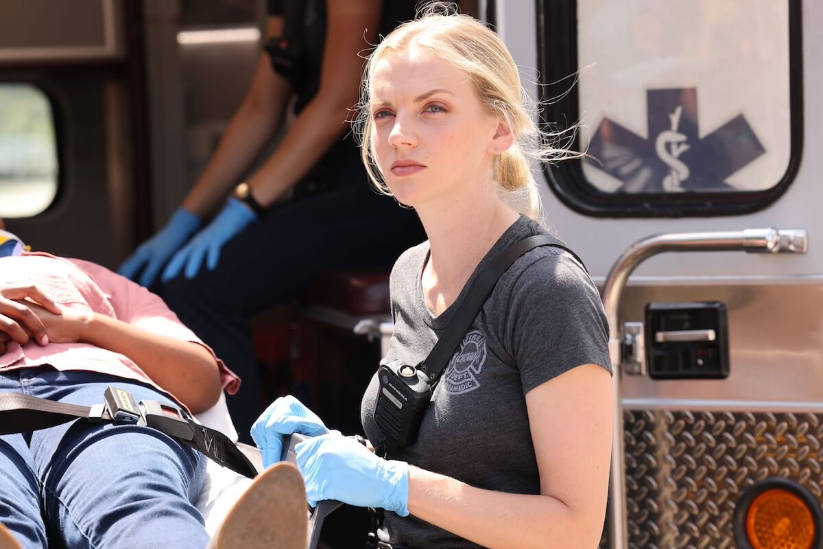 Kara Killmer as Sylie Brett standing in front of an open ambulance in 'Chicago Fire'