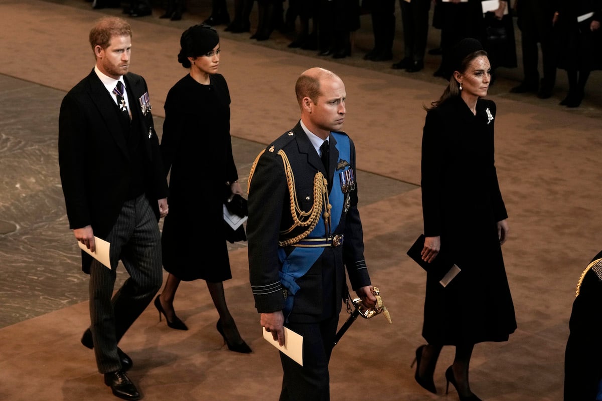 Kate Middleton, who asked Prince Harry a question ahead of Queen Elizabeth's funeral, walks with Prince Harry, Meghan Markle, and Prince William