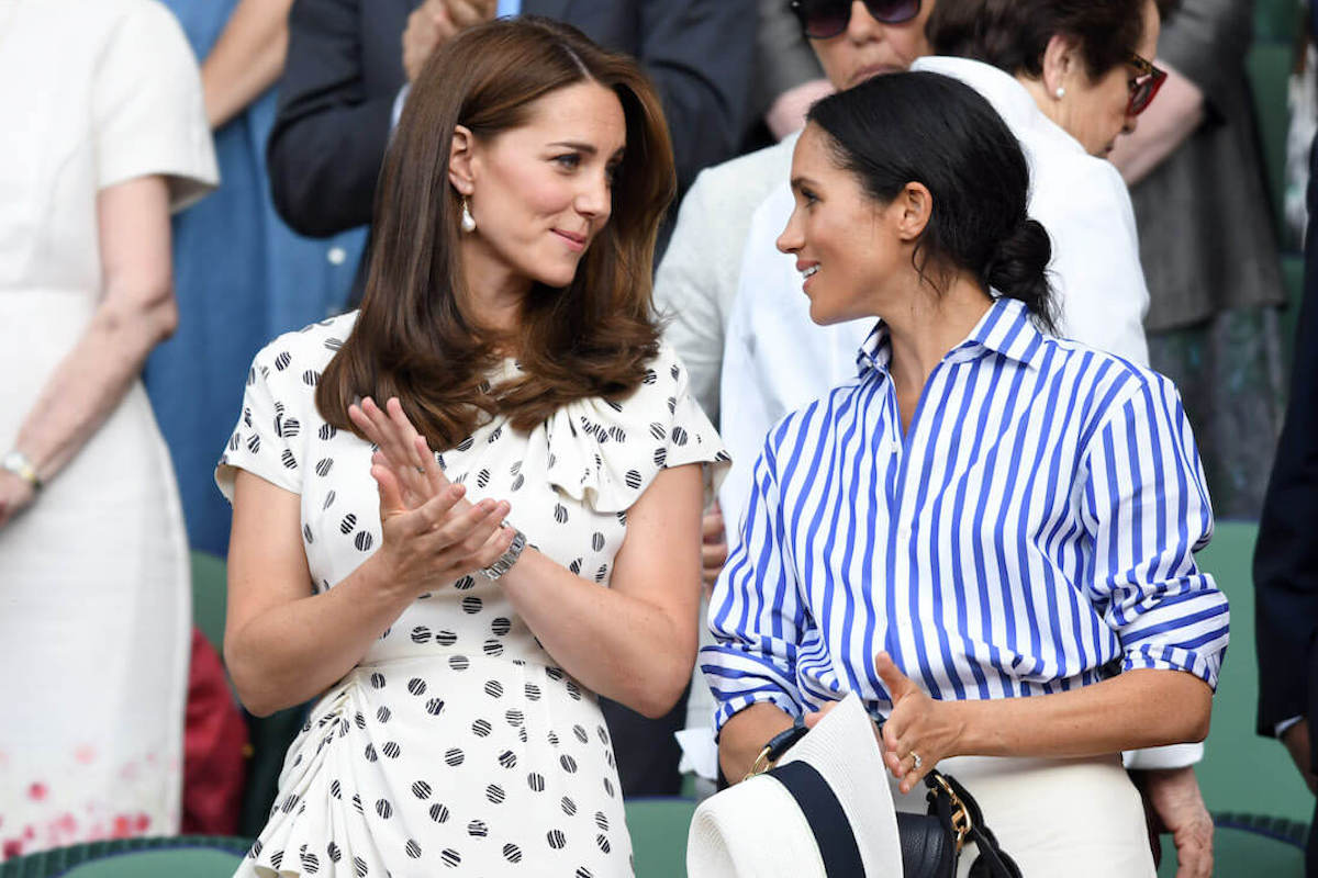 Kate Middleton, who, per 'Endgame,' 'shudders and giggles' hearing Meghan Markle's name, stands with Meghan Markle