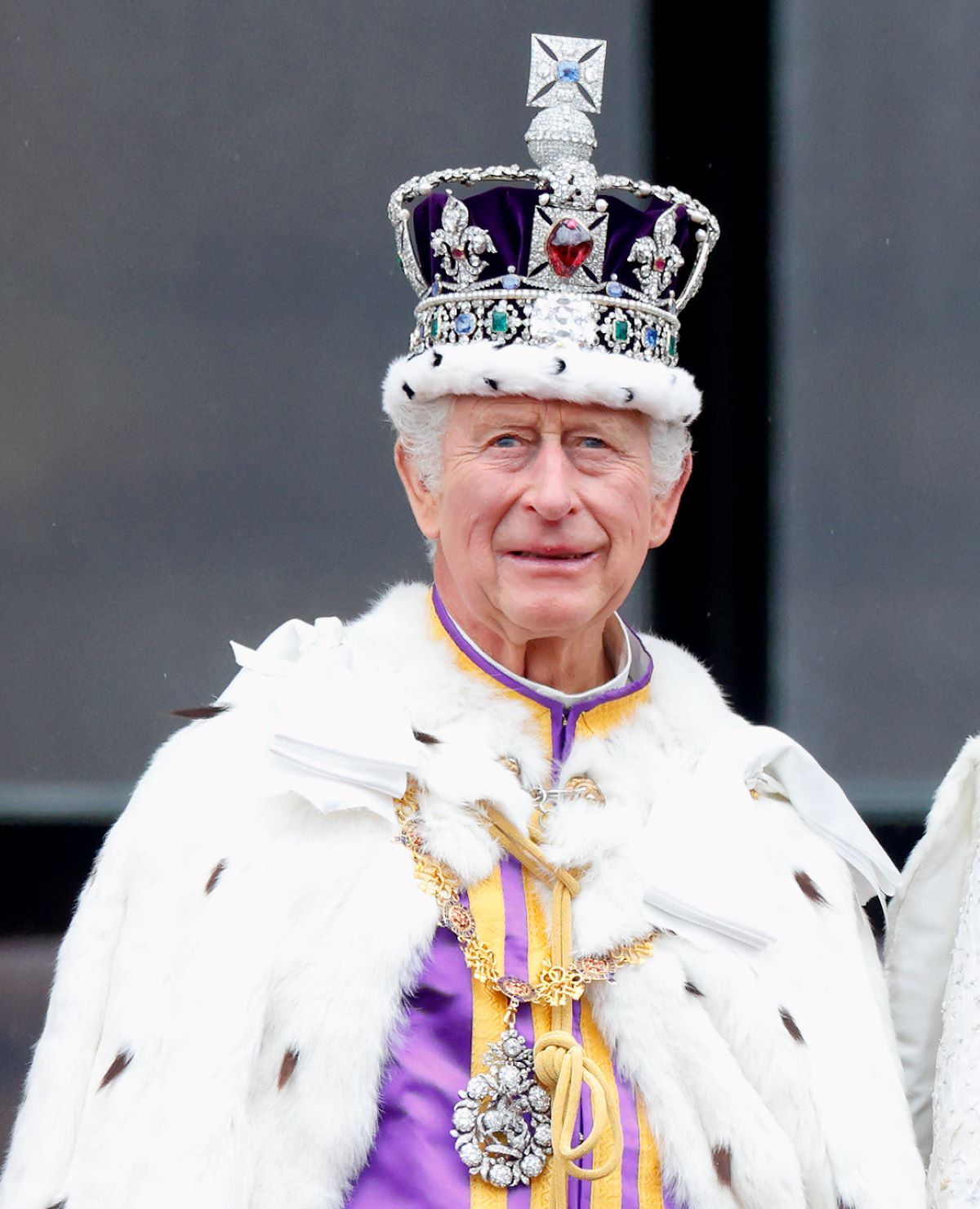 King Charles III watches an RAF flypast from the balcony of Buckingham Palace following his and Queen Camilla's coronation