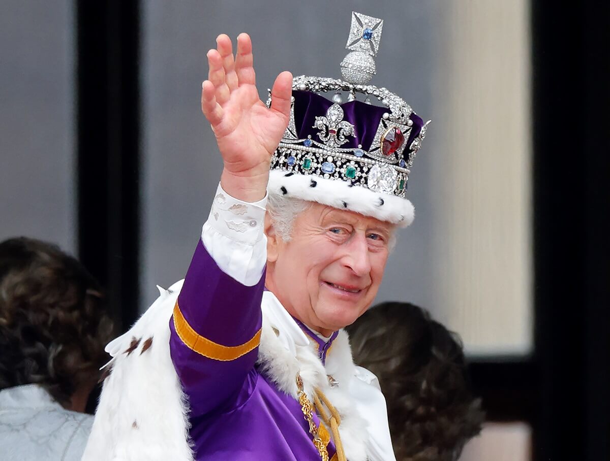 King Charles III waves from the balcony of Buckingham Palace following his coronation