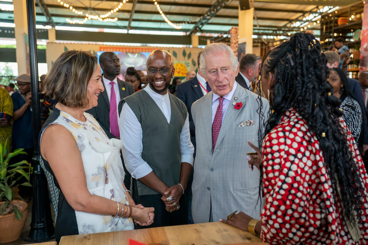 King Charles III, who visited a food truck during a royal tour of Kenya, talks to a group of people