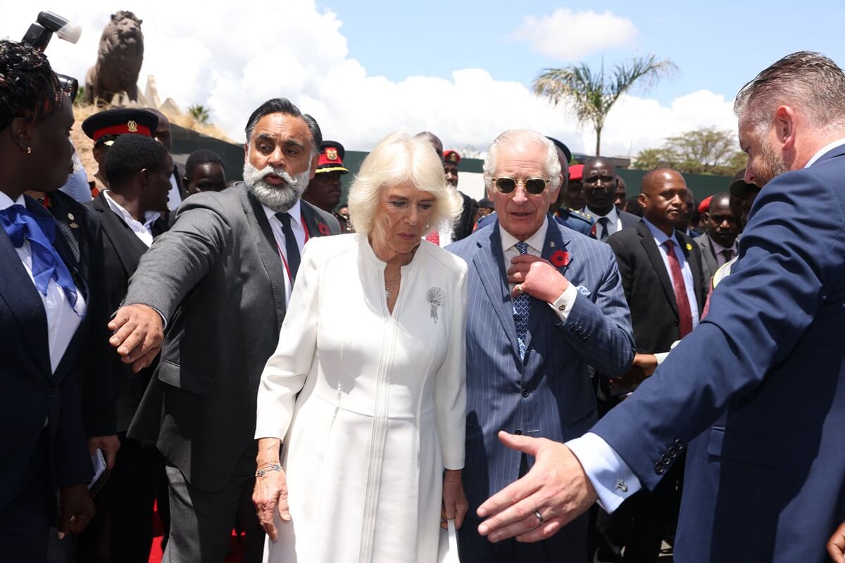 King Charles and Queen Camilla, who a body language expert says put Charles' safety before her own, visit a museum in Nairobi, Kenya