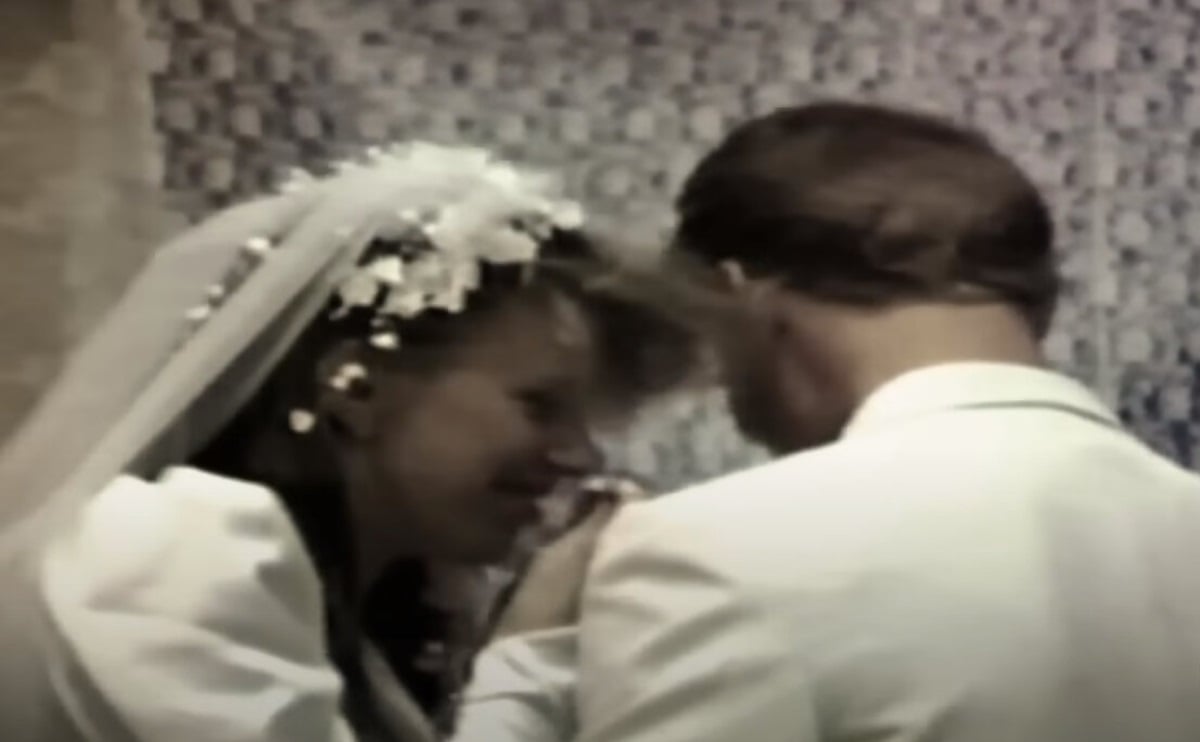 Meri Brown, in a wedding gown, smiles while Kody Brown feeeds her cake at their 1990 wedding