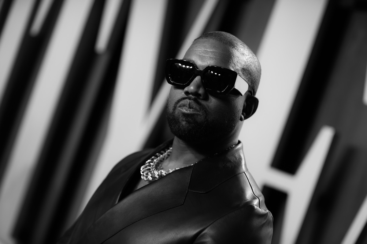 Kanye West posing with sunglasses at the Vanity Fair Oscar party.