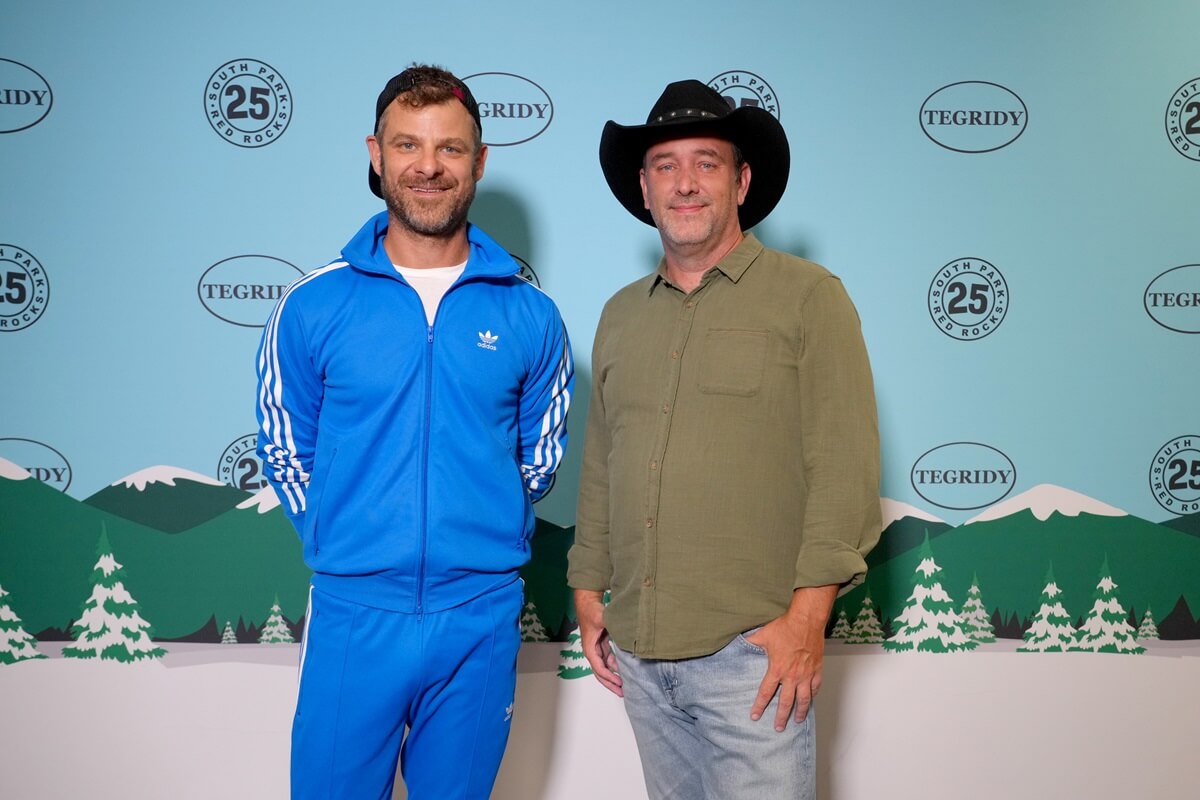 Matt Stone and Trey Parker posing next to each other at the South Park The 25th Anniversary Concert at Red Rocks.