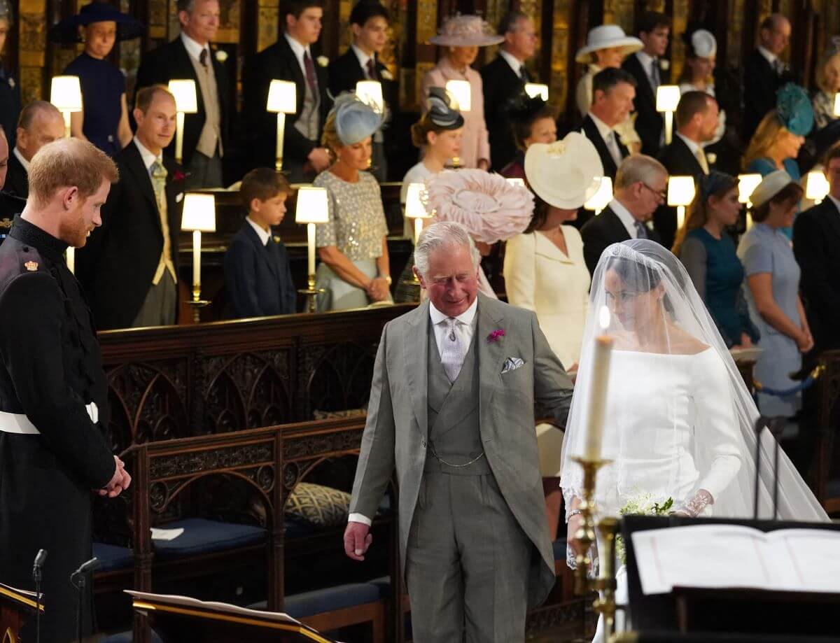 Meghan Markle arrives at the altar accompanied by then-Prince Charles to marry Prince Harry