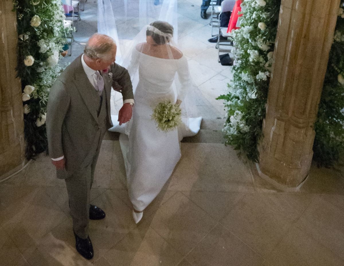 Meghan Markle walks up the aisle with then-Prince Charles in St. George's Chapel at Windsor Castle